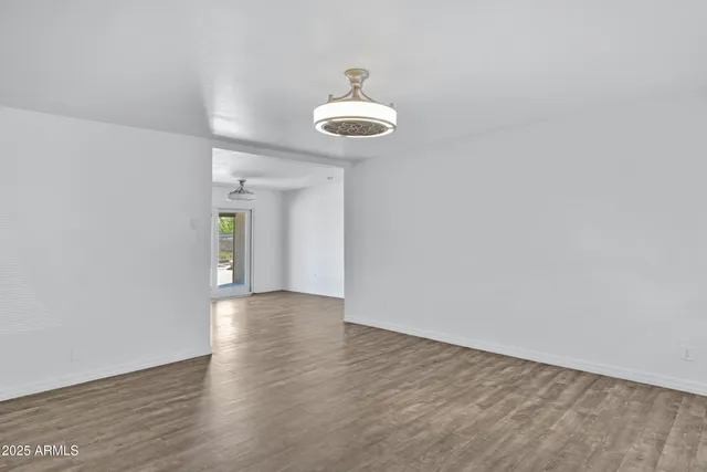 a view of a room with wooden floor and windows