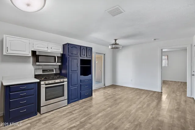 a kitchen with stainless steel appliances granite countertop a stove and a refrigerator