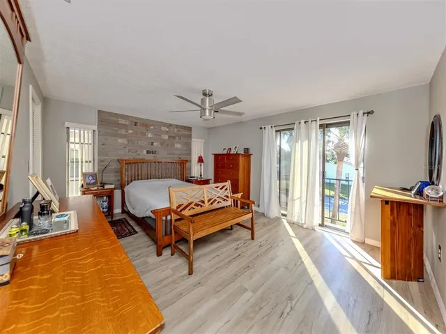 a bedroom with a bed and a flat tv screen on the dresser