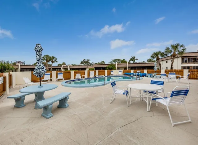 a view of a patio with dining table and chairs