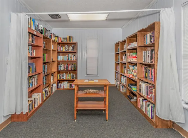 a living room with a bookshelf and a book shelf