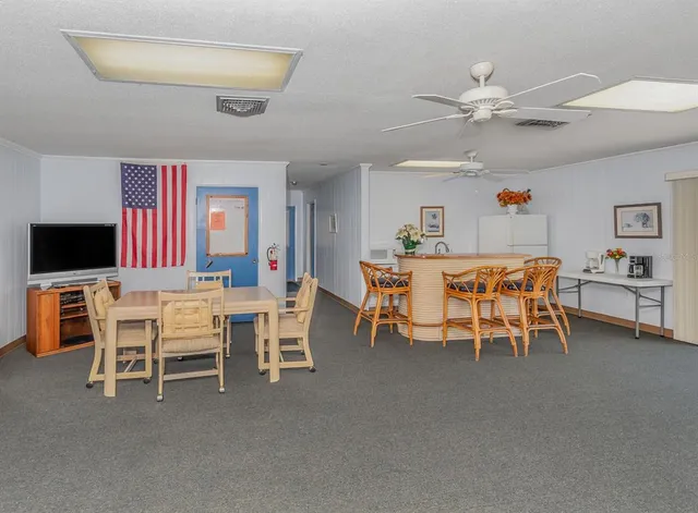 a view of a dining room with furniture and a chandelier