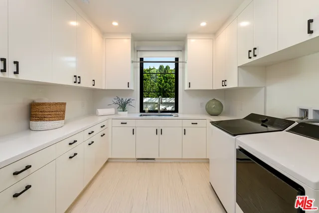 a kitchen with appliances cabinets and a sink