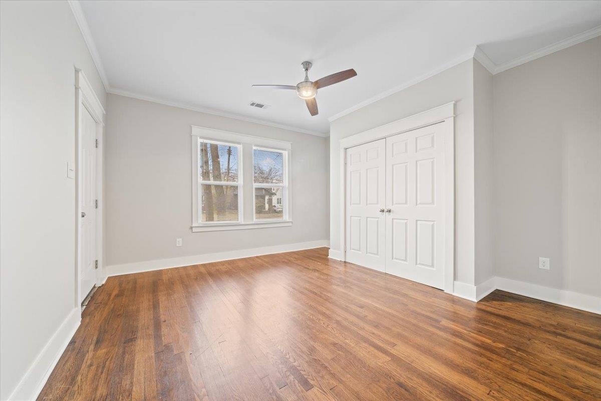 598 Spring Street Memphis, TN 38112 - Photo 14 of 29 a view of empty room with wooden floor and fan