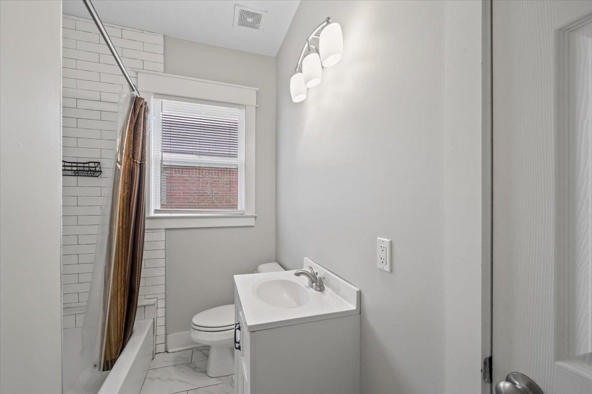598 Spring Street Memphis, TN 38112 - Photo 21 of 29 a bathroom with a sink toilet and mirror
