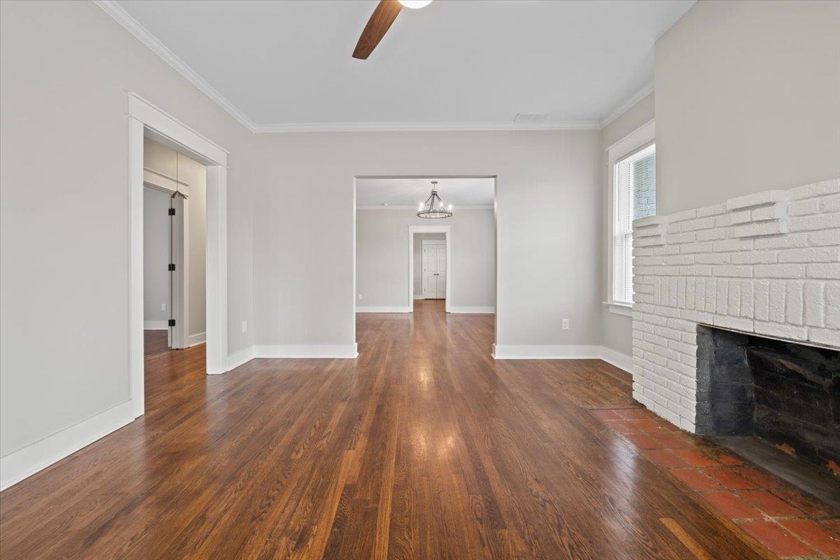 598 Spring Street Memphis, TN 38112 - Photo 7 of 29 an empty room with wooden floor and fireplace