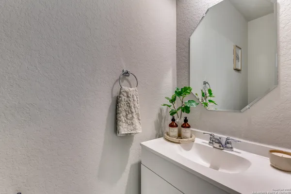 a bathroom with a sink a vanity and a mirror
