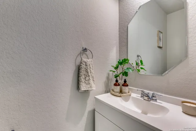 a bathroom with a sink a vanity and a mirror