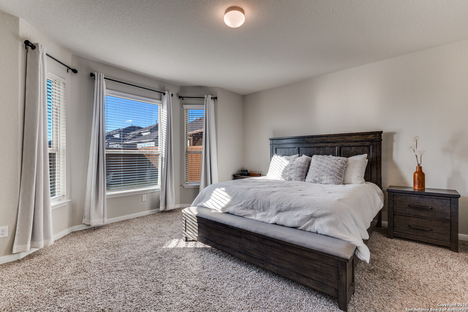 4807 Marylebone Avenue Converse, TX 78109 - Photo 12 of 25 a large bed sitting in a bedroom next to a window and a larger closet