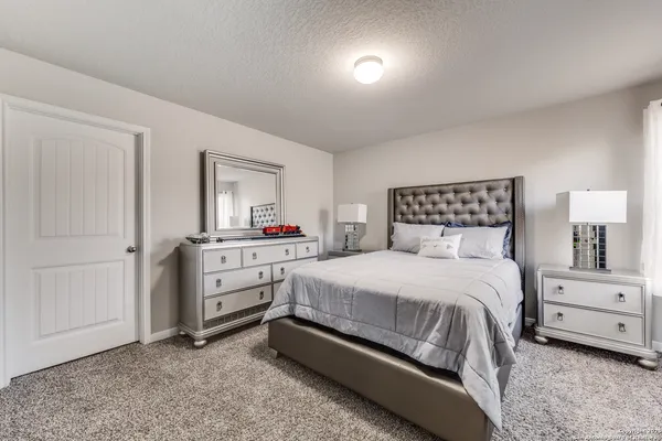 a bedroom with a bed and a dresser