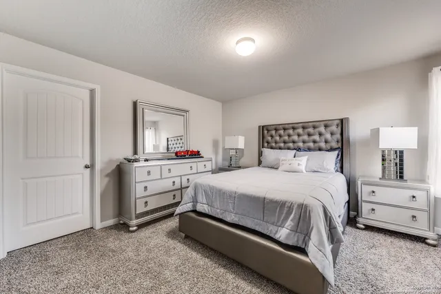 a bedroom with a bed and a dresser