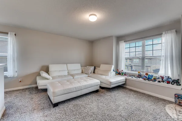 a living room with furniture and windows
