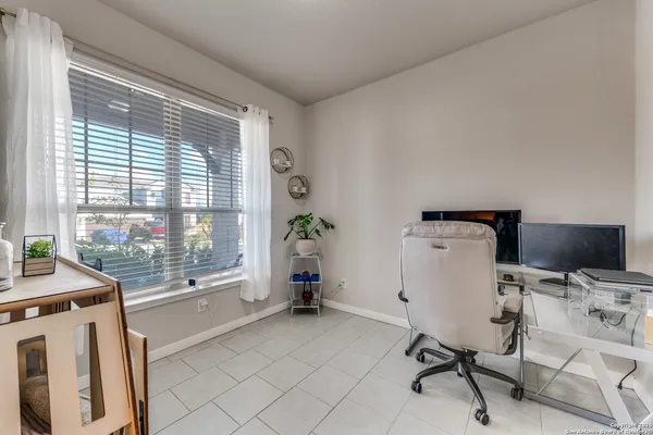 a view of a workspace with furniture and a window