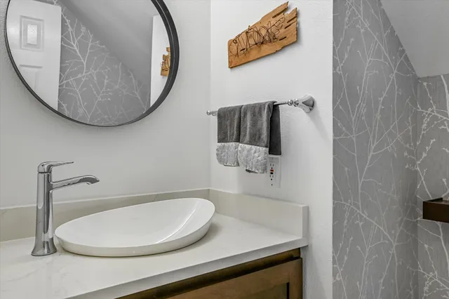 a bathroom with a sink and a mirror
