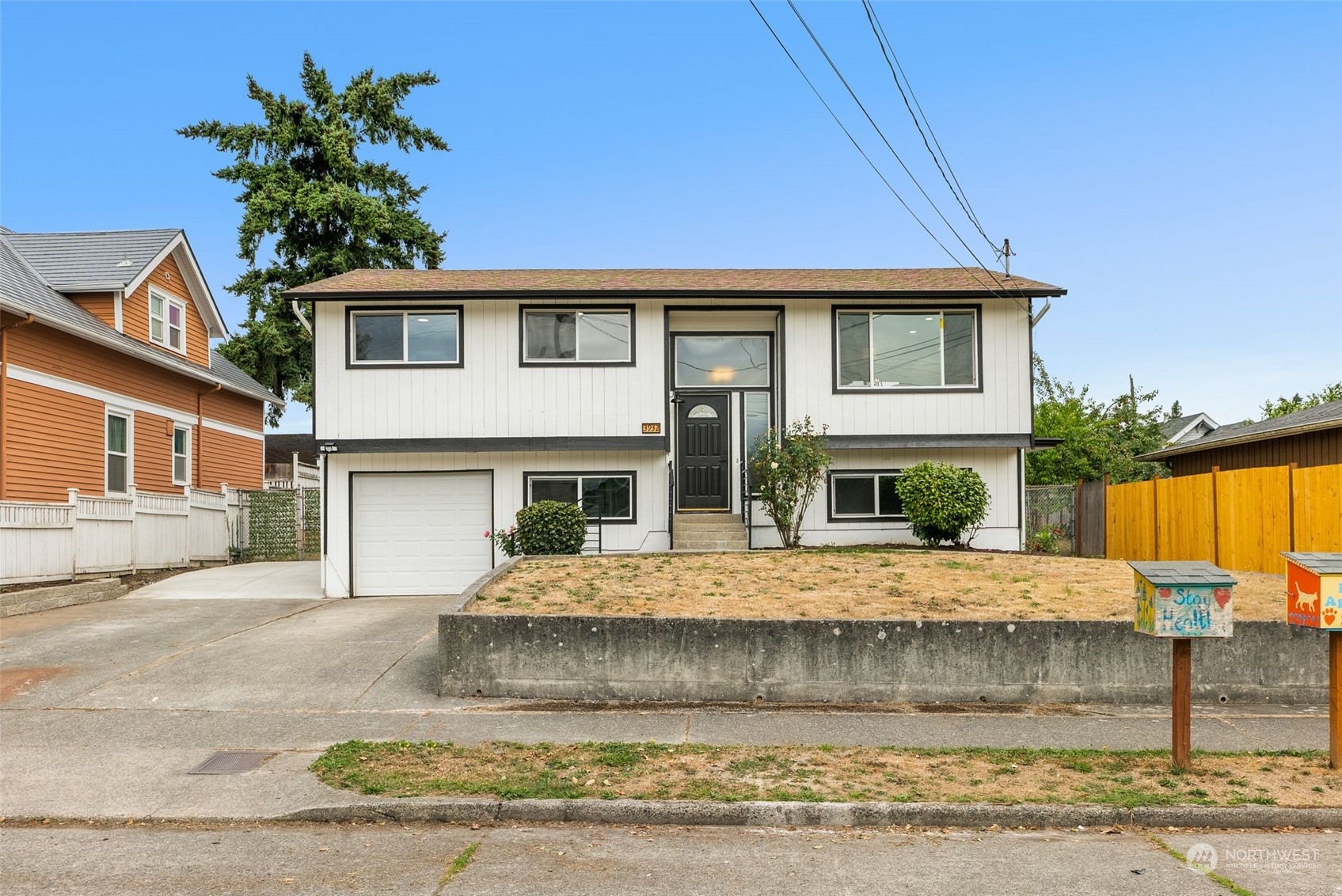 3932 South Morgan Street Seattle, WA 98118 - Photo 1 of 40 a front view of a house with a yard