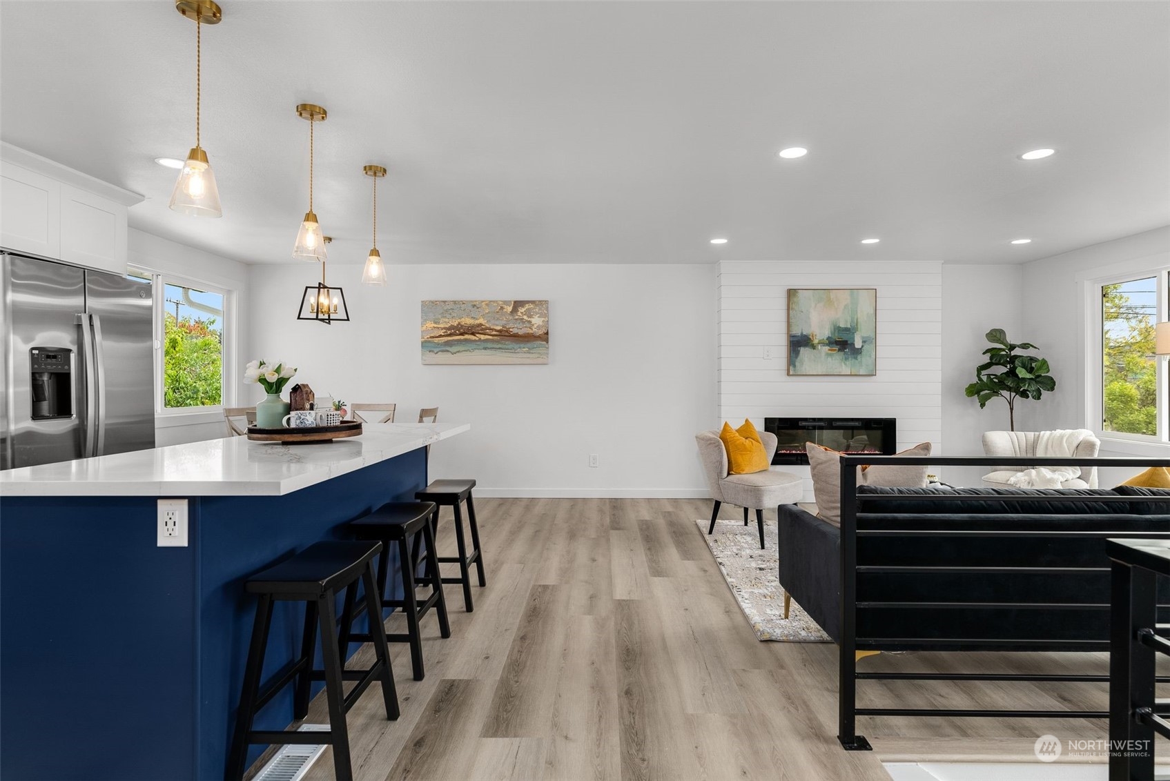 3932 South Morgan Street Seattle, WA 98118 - Photo 13 of 40 a kitchen with stainless steel appliances kitchen island granite countertop a table and chairs in it