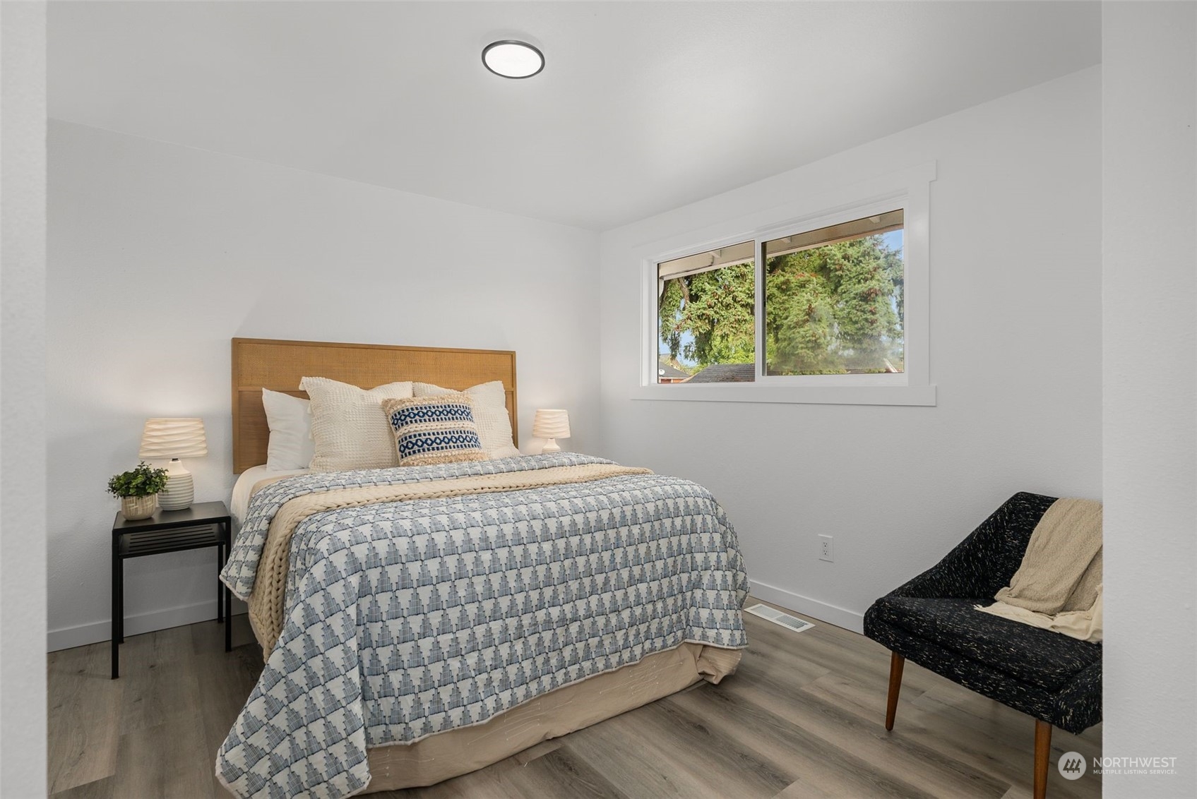 3932 South Morgan Street Seattle, WA 98118 - Photo 15 of 40 a bedroom with a bed and wooden floor