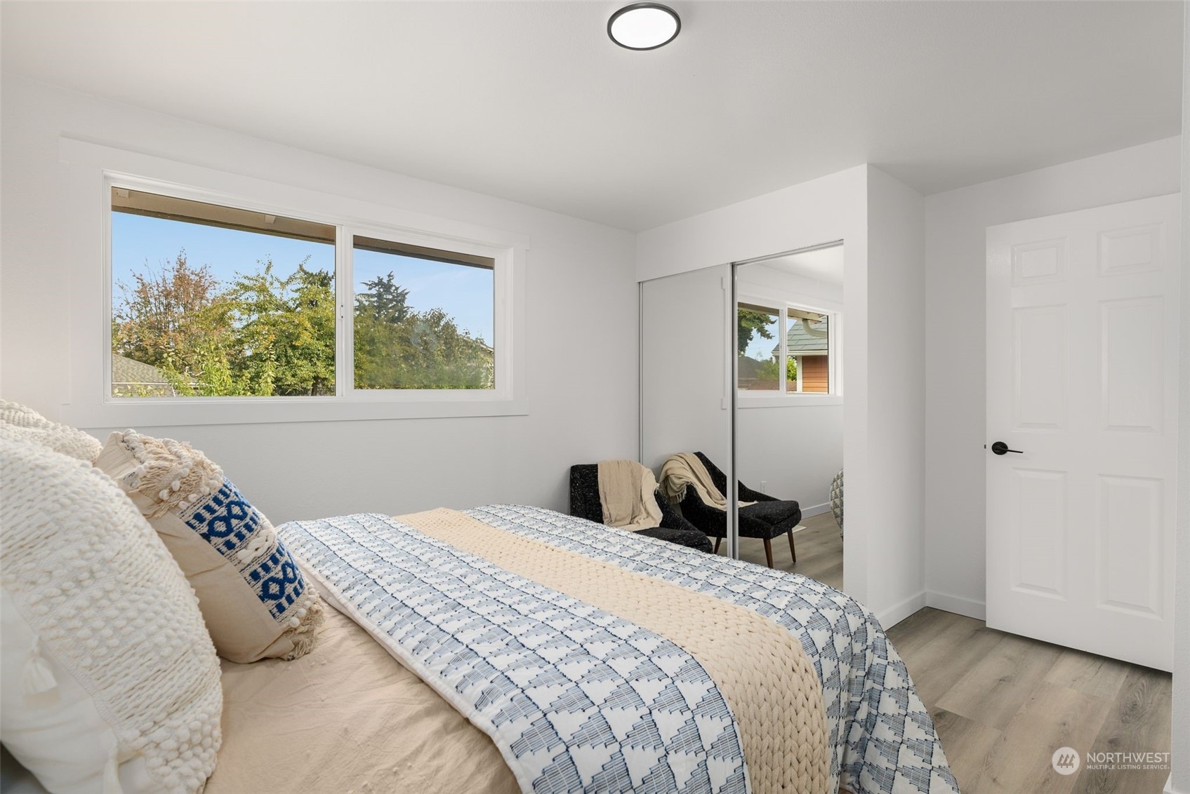 3932 South Morgan Street Seattle, WA 98118 - Photo 16 of 40 a bedroom with a bed and a painting on the wall