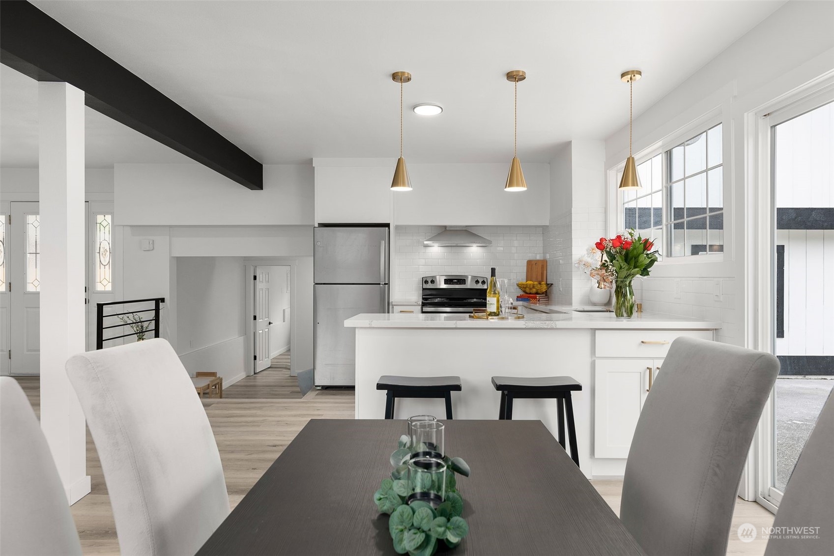 3932 South Morgan Street Seattle, WA 98118 - Photo 24 of 40 a living room with kitchen island furniture and a chandelier