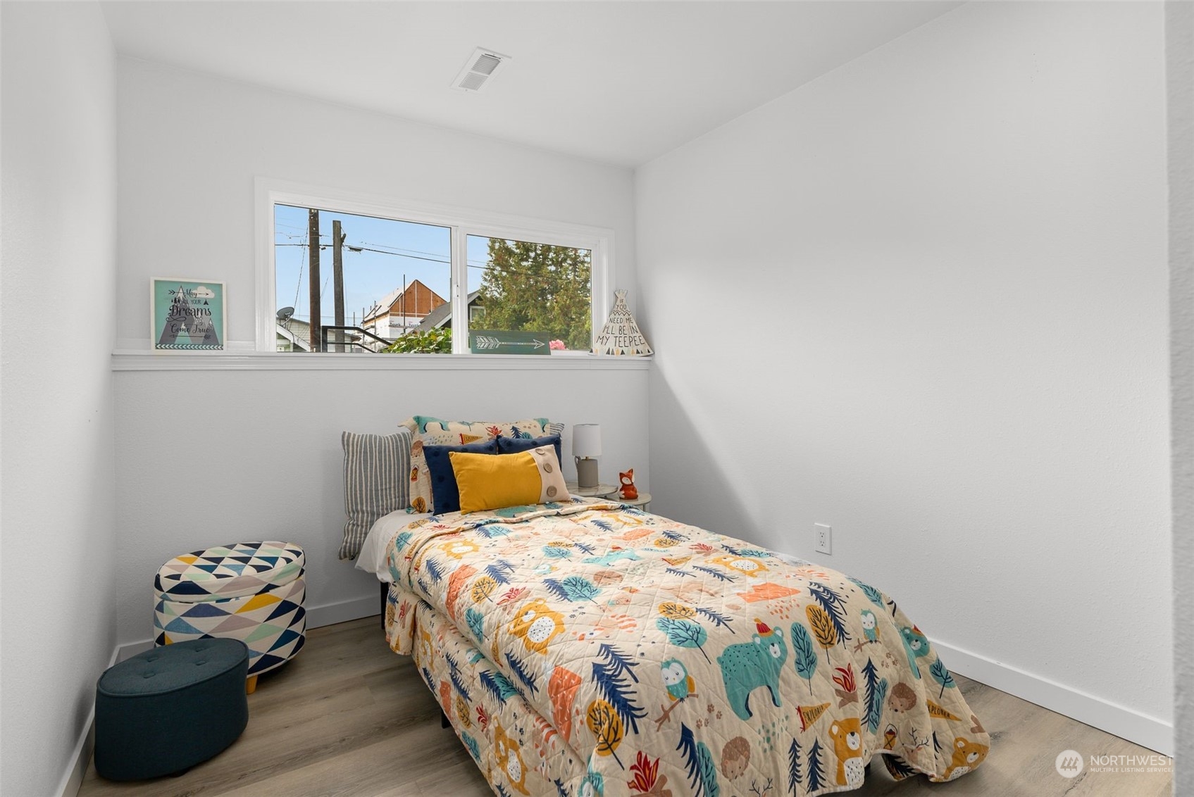 3932 South Morgan Street Seattle, WA 98118 - Photo 30 of 40 a bedroom with a bed and wooden floor
