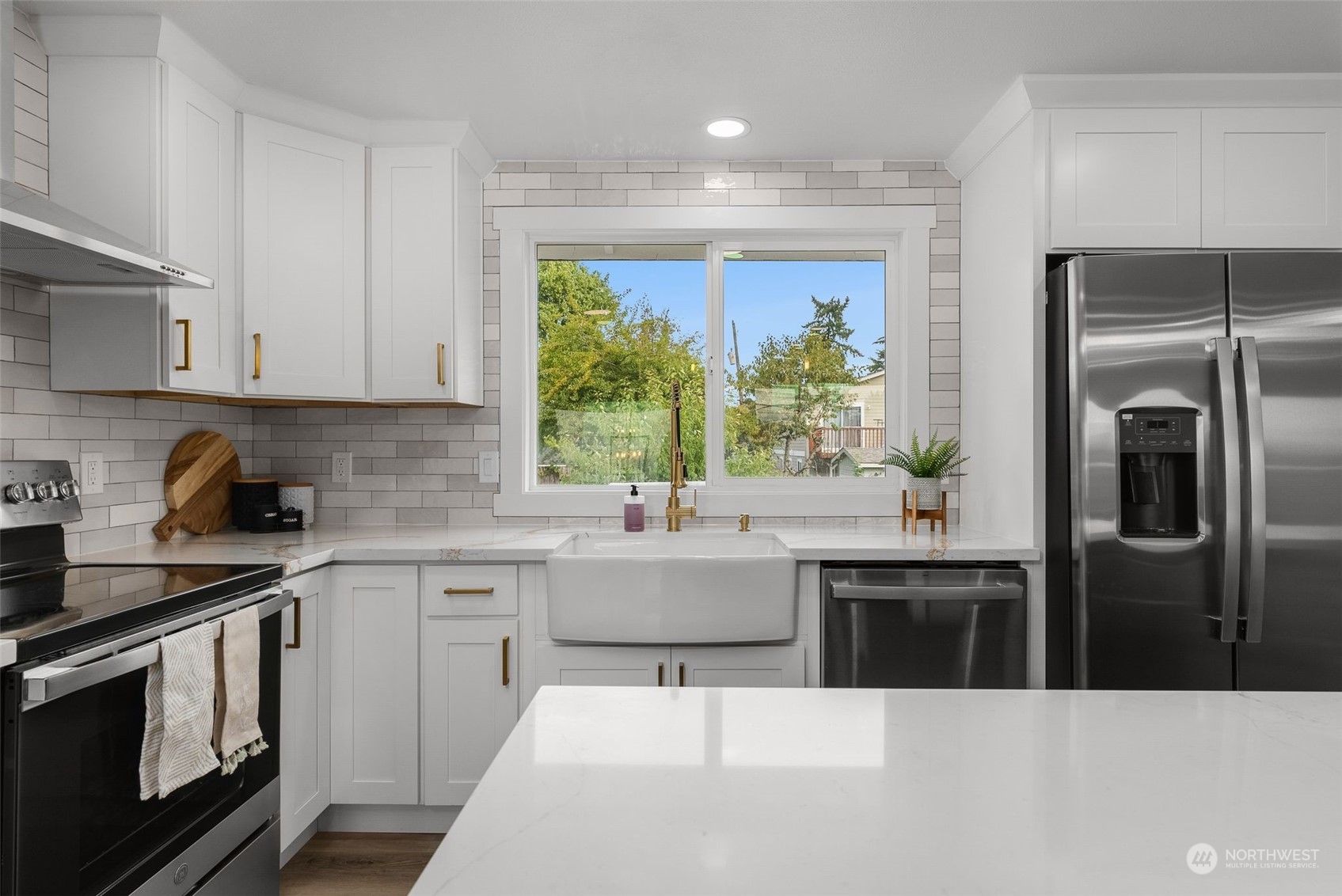 3932 South Morgan Street Seattle, WA 98118 - Photo 10 of 40 a kitchen with stainless steel appliances kitchen island a sink a stove and refrigerator