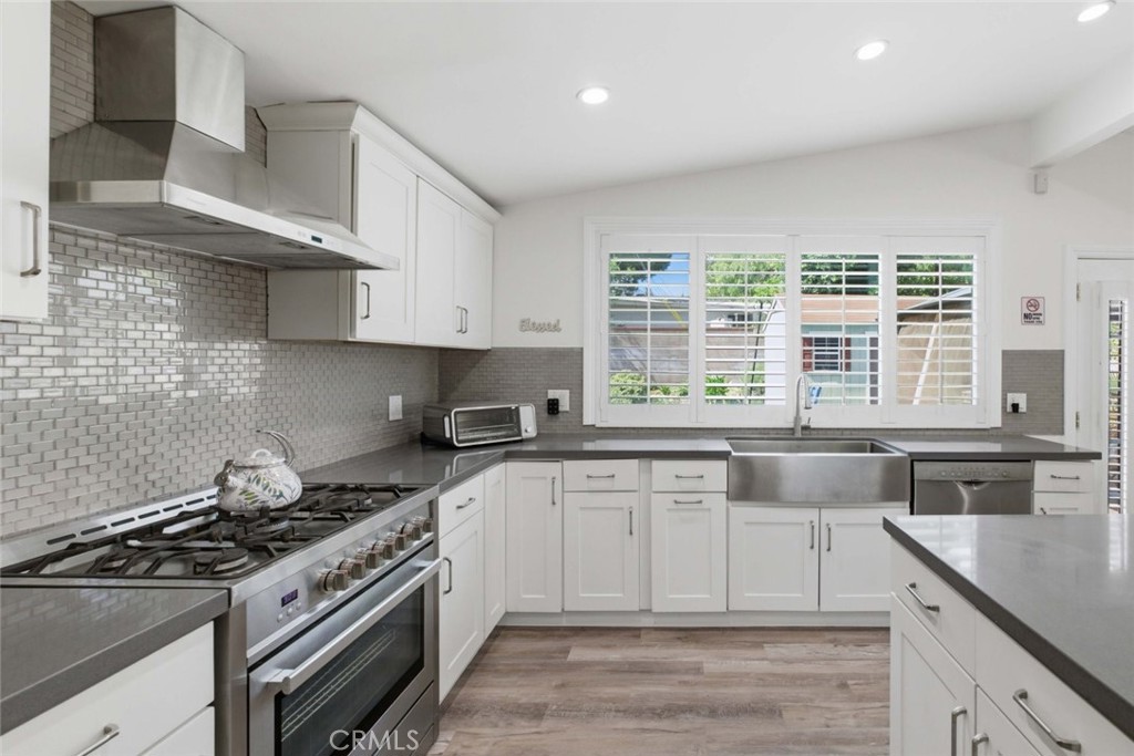 301 West Ashby Street Azusa, CA 91702 - Photo 23 of 75 a kitchen with stainless steel appliances granite countertop a sink stove and cabinets