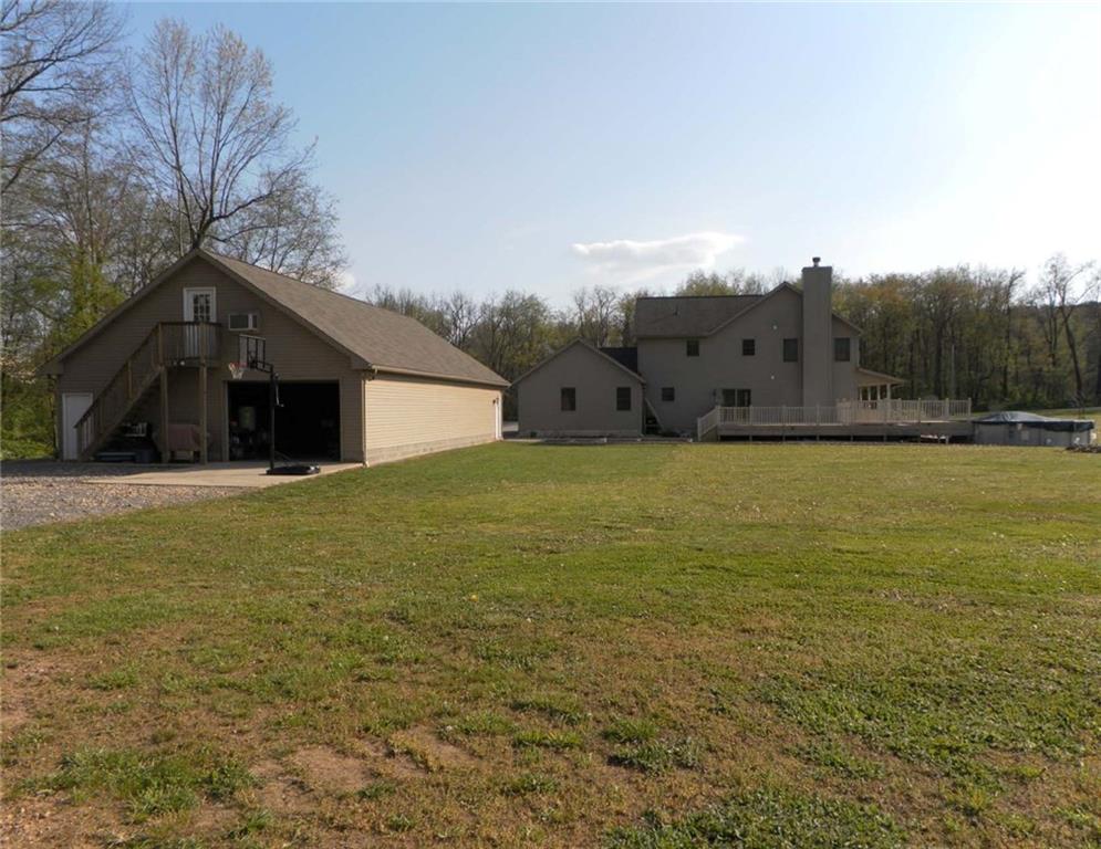 130 Vance Road New Castle, PA 16102 - Photo 2 of 25 Back Exterior of house with extra-large deck, 21 foot pool & 7-person hot tub and a 64x32 garage with a 2nd floor also.