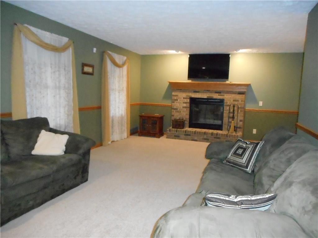 130 Vance Road New Castle, PA 16102 - Photo 5 of 25 Extra large living room with a brick wood burning fireplace.