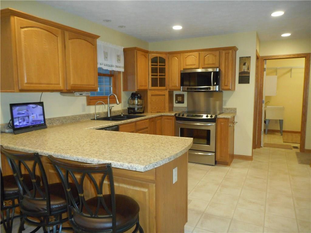 130 Vance Road New Castle, PA 16102 - Photo 8 of 25 Fully equipped kitchen with upgraded stainless steel appliances including a convection oven. Laundry room is near for multi-tasking.