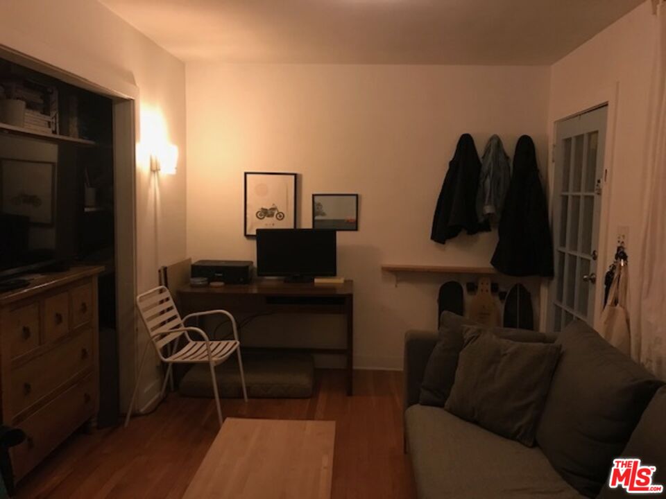 223 Strand Street, Unit G Santa Monica, CA 90405 - Photo 6 of 6 a living room with furniture a flat screen tv and a window