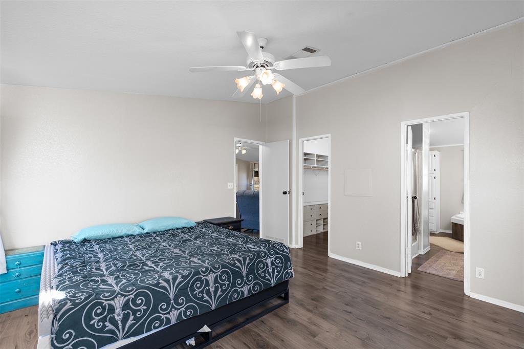 181 Pr 125 Whitney, TX 76692 - Photo 16 of 34 Bedroom featuring a walk in closet, dark wood-style flooring, and ceiling fan