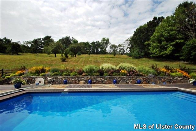 451 Scarawan Road Stone Ridge, NY 12484 - Photo 4 of 15 a view of a water fountain and a bench in the lake