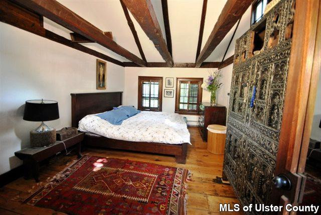 451 Scarawan Road Stone Ridge, NY 12484 - Photo 8 of 15 a bedroom with a bed and wooden floor