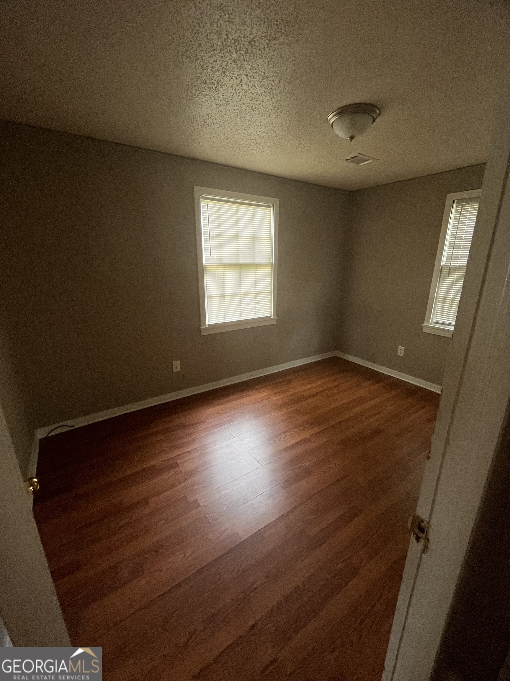 2328 Getzen Street Augusta, GA 30906 - Photo 6 of 10 features reddish-brown wood-look laminate flooring