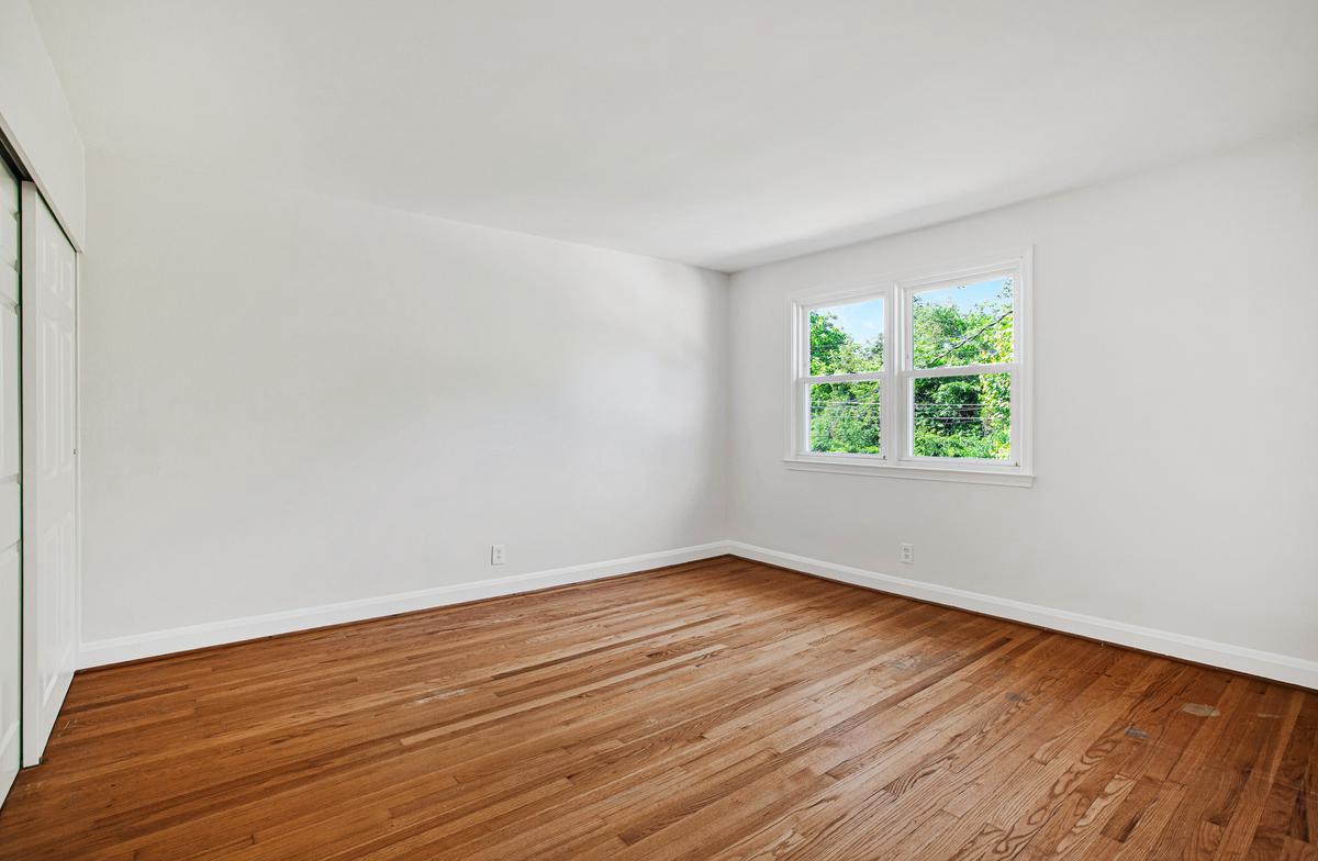 1016 Winsford Road Towson, MD 21204 - Photo 19 of 42 an empty room with wooden floor and window