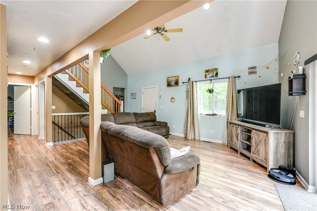 15980 Adams Road Middlefield, OH 44062 - Photo 24 of 49 Living room with ceiling fan, light hardwood / wood-style flooring, and vaulted ceiling