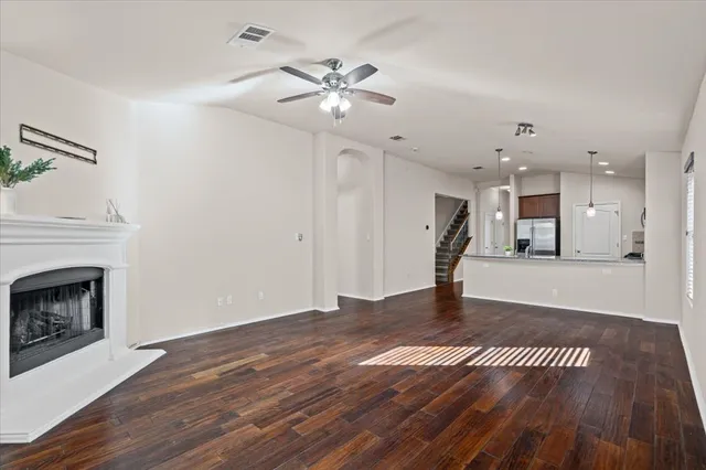 a view of empty room with wooden floor and fireplace