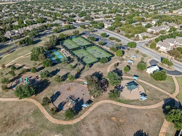 an aerial view of a house with a yard