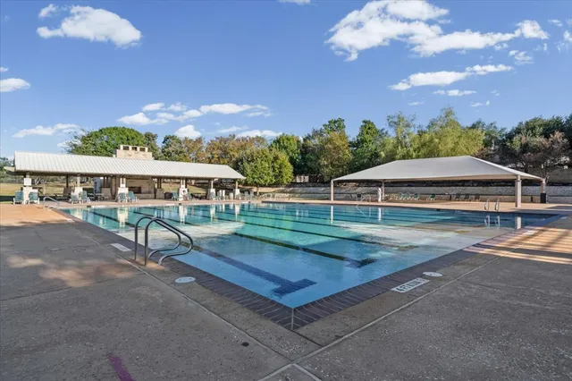 a view of a house with swimming pool and a yard