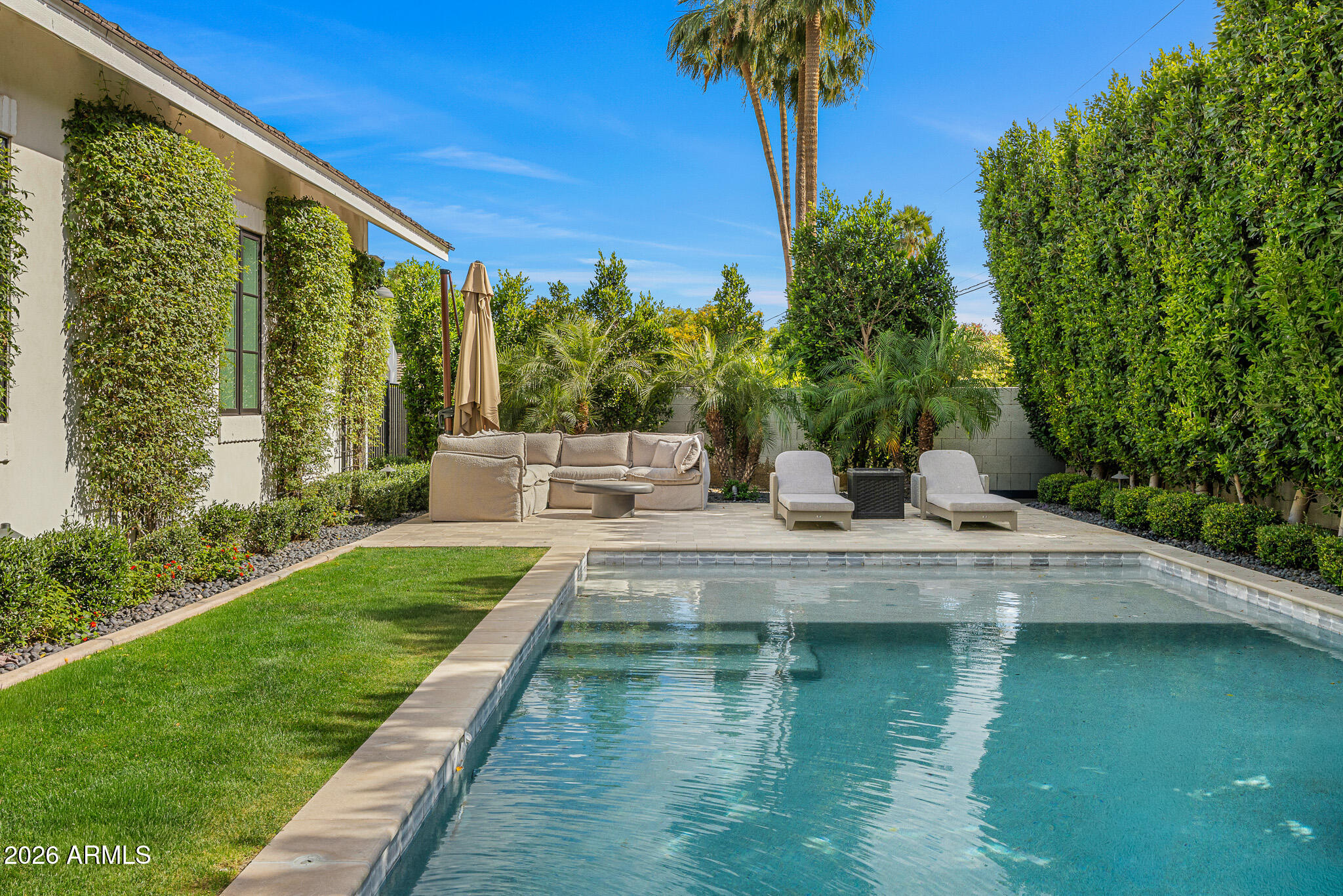 4204 North 57th Way Phoenix, AZ 85018 - Photo 6 of 34 a view of a swimming pool with a garden