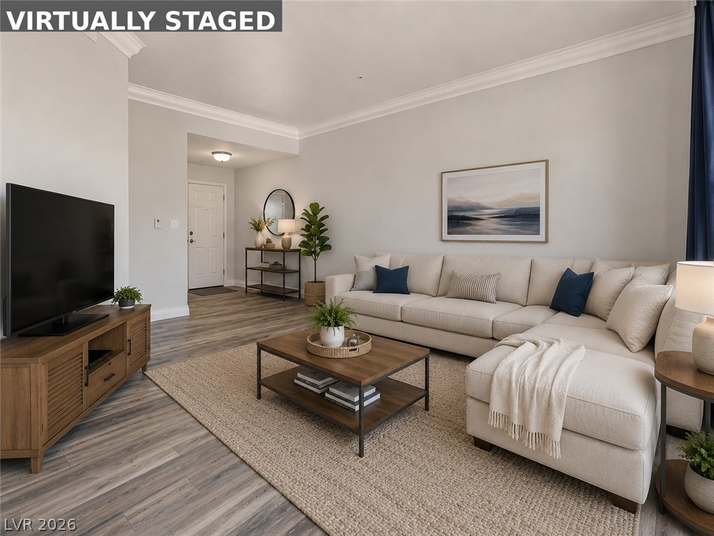 260 East Flamingo Road, Unit 220 Las Vegas, NV 89169 - Photo 29 of 32 Elegant crown molding accents this inviting living room, offering a seamless flow to the entry.