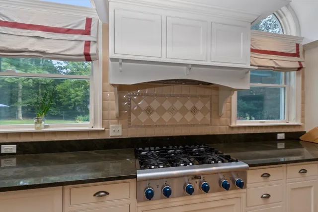 a kitchen with a stove and a white cabinet