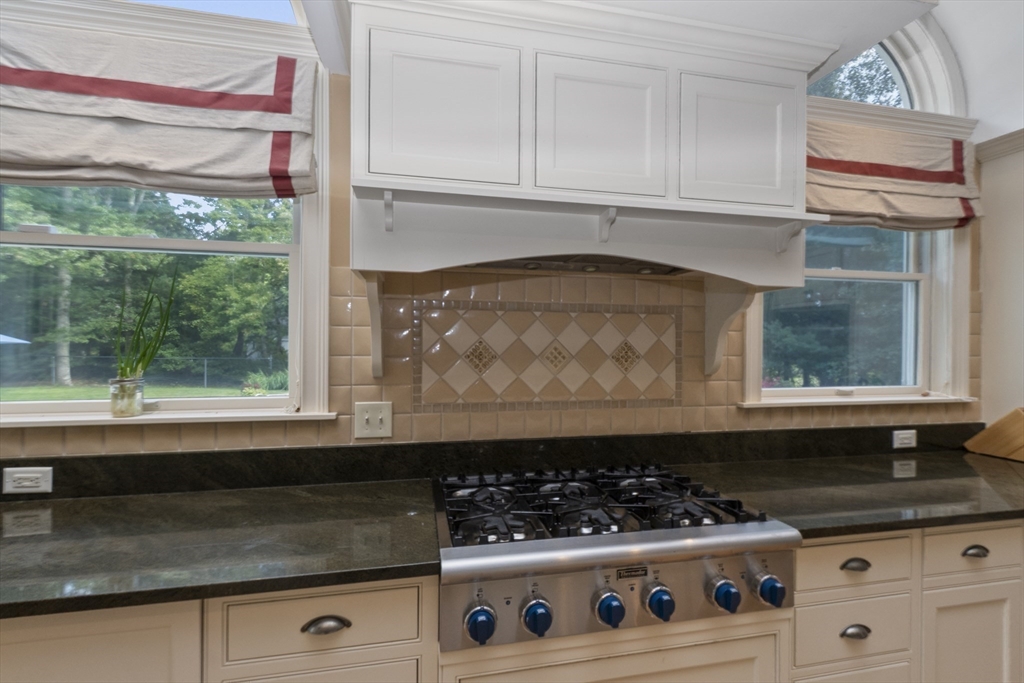 6 Heron Way Mashpee, MA 02649 - Photo 15 of 42 a kitchen with a stove and a white cabinet