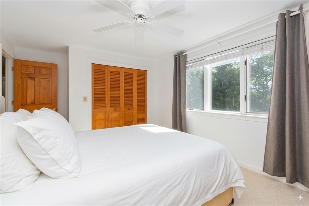 6 Heron Way Mashpee, MA 02649 - Photo 31 of 42 a bedroom with a large bed and a large window