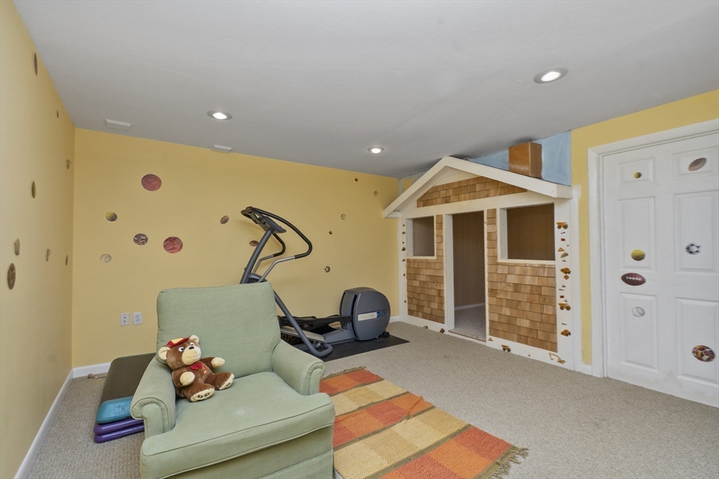 6 Heron Way Mashpee, MA 02649 - Photo 34 of 42 a bedroom with furniture and a chandelier