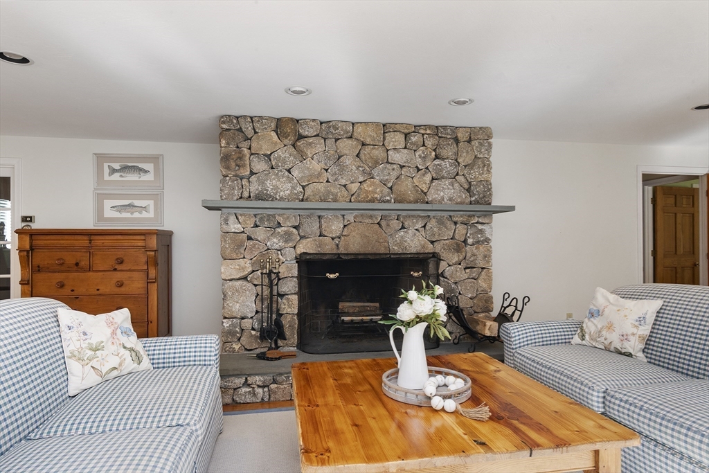 6 Heron Way Mashpee, MA 02649 - Photo 7 of 42 a living room with furniture and a fireplace