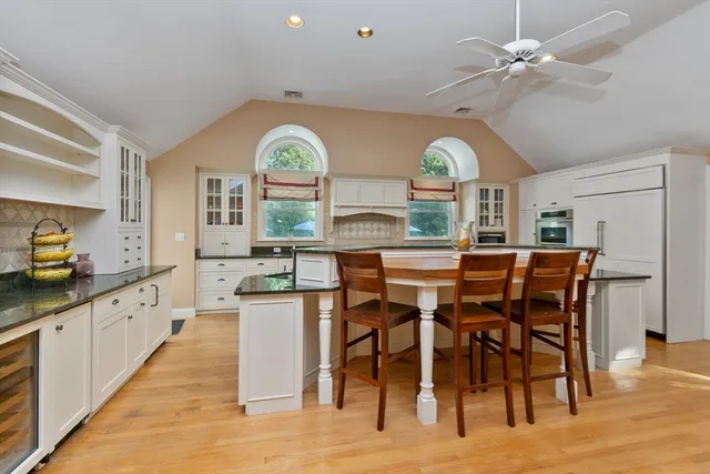 a kitchen with stainless steel appliances a dining table chairs and chandelier