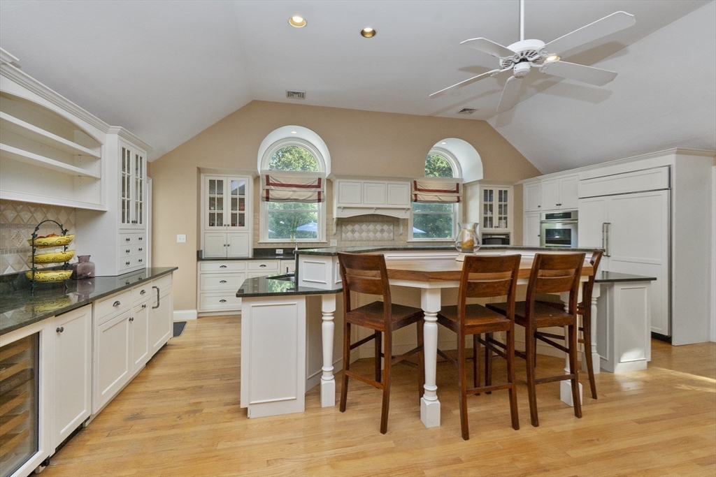 6 Heron Way Mashpee, MA 02649 - Photo 10 of 42 a kitchen with stainless steel appliances a dining table chairs and chandelier