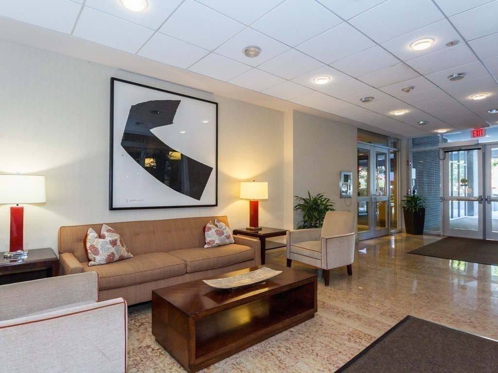 44 Washington Street, Unit 304 Brookline, MA 02445 - Photo 13 of 15 a living room with furniture and a wooden floor