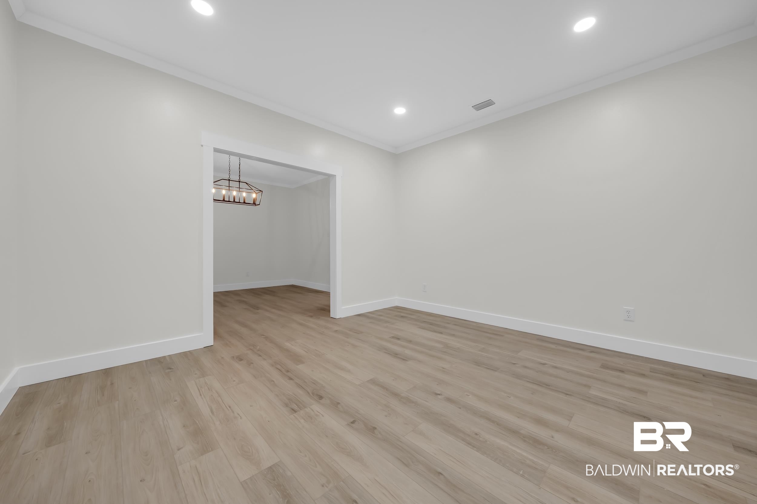 4924 Brooke Court Mobile, AL 36618 - Photo 7 of 34 Empty room with light wood-type flooring, recessed lighting, ornamental molding, and a chandelier